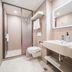 Hanting Hotel Shenyang Santaizi Metro Station bathroom with shower, toilet, sink and illuminated mirror in Shenyang