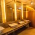 Big Hotel Suites Mandaue City restroom with vessel sinks, lit mirrors and private stall partitions