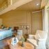 Relais du Bois Saint Georges in Saintes: cozy wood-paneled bedroom with bed, armchair, and lounge table