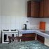 S&C Hotel Suites and Apartments kitchen in Koror with stove, sink, cabinets, and dining table