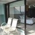 Ganga Beach Resort in Rishikesh with sliding glass doors to a room and two white chairs on the balcony