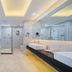 Marriott Hotel Yunfu bathroom with freestanding tub, glass shower, double vanity and large mirror