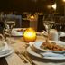 Real Marina Hotel & Spa in Olhão dining table set with wine glasses, candlelight and plated pasta