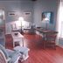 Mckinley Edwards Inn in Bryson City living room with sofa, chairs, lamp, and wood floors