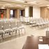 Thotel Lamezia conference room with rows of white chairs and presentation table in Feroleto Antico