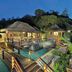 Constance Lemuria in Grand'Anse Praslin: overwater pool villas with lit decks at dusk