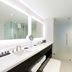 Pickering Casino Resort bathroom with double vanity, large mirror, glass shower and clean white finishes in Pickering