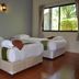 B Square Hotel at Khanom guest room with two twin beds and a large window view