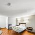 Motel 6 Moultrie, GA guest room with bed, TV, desk, mini fridge and wood-look flooring
