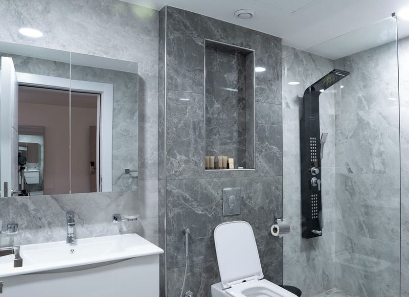 Plaza Athenee Hotel Kuwait City bathroom with walk-in shower, vanity, and toilet
