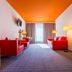 Park Inn by Radisson Frankfurt Airport room with red seating, lamps and orange ceiling in Frankfurt am Main