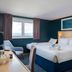 Travelodge Amesbury Stonehenge guest room with two beds and a window view in Salisbury