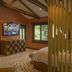 Villa Blanca Cloud Forest Hotel + Retreat room with TV, wooden beams, and window views in San Ramón