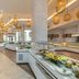 Hilton Skanes Monastir Beach Resort buffet area with hanging lanterns and bright marble floors in Monastir