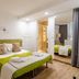 Domatia in Barletta guest room with green-accented bed, mirrored wardrobe, and wood flooring
