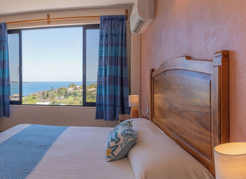 Hotel El Mirador in Puerto Escondido room with king bed and ocean view through large window