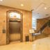 City Hotel Shanghai lobby with elevator, staircase, and potted tree in Shanghai