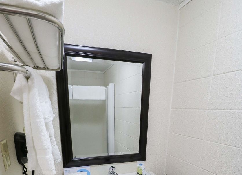 Bear Lodge Motel Sundance bathroom vanity with mirror, sink, and towel rack