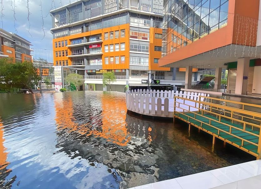 Signature Hotel by Easy Nap in Puchong with canal-side walkway and modern building reflections