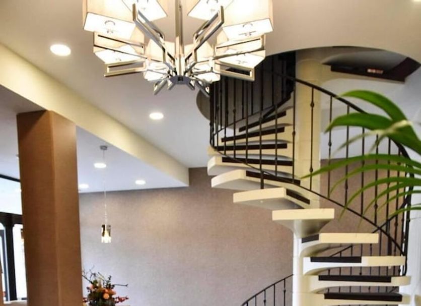 Martins Klause Airport Messe Hotel lobby with spiral staircase and chandelier in Leinfelden-Echterdingen