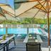 Outdoor poolside terrace at Novotel Toulouse Centre Compans Caffarelli in Toulouse with umbrellas and lounge chairs
