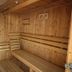 Wood-paneled sauna at Hôtel La Métairie in Cordes-sur-Ciel with wooden benches and heater