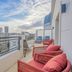 Yuna Porte-Maillot aparthotel in Paris balcony with red chairs and city skyline view