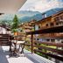 Hotel Bristol Verbier balcony with mountain and village views in Bagnes