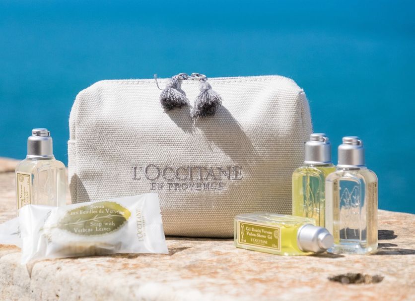 Hotel Henry's House Siracusa spa amenity set with L'Occitane pouch, soaps and toiletries by the sea