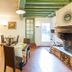 Logis Auberge La Cremaillere in Villandraut dining room with set tables, fireplace, and green ceiling beams