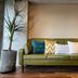 We Come Hostel Taipei City lobby with green sofa, patterned pillows, and potted plant