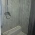 Self Contained Rooms in Central Torquay shower stall with grey tiled walls and handheld shower, Torquay
