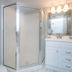 Pelican Beach Resort & Conference Center bathroom with glass shower and white vanity in Destin