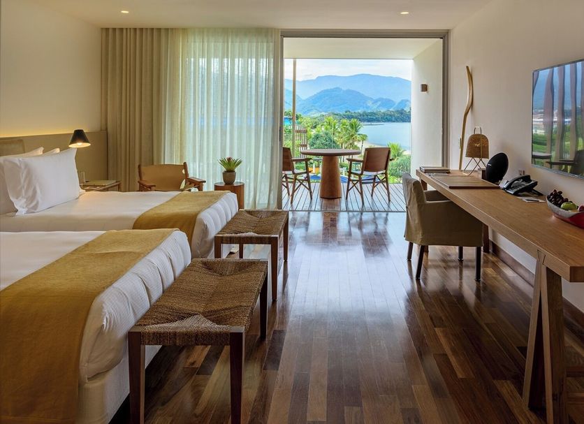 Hotel Fasano Angra dos Reis room with twin beds, lake view balcony, and desk overlooking mountains