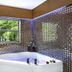 The Garden Hotel & Resort in Fort Lauderdale bathroom with corner soaking tub and mosaic tile walls