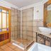 Sunward Park Guest House & Conference Centre bathroom with glass shower, vanity sink and bathtub in Boksburg