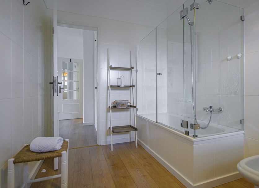 Casa das Hortênsias - Charming Guest House bathroom with bathtub, glass shower, and wooden floor in Sintra