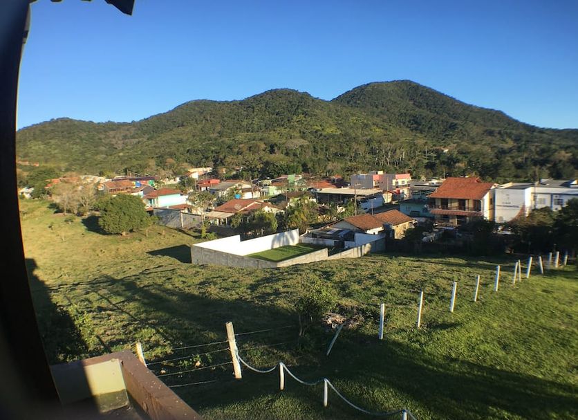 Hotel Panoramico in Penha with mountain views, green hillside, and rooftops under a clear blue sky