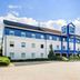 Ibis Budget Dresden Kesselsdorf exterior with blue-and-white facade and parking lot in Kesselsdorf