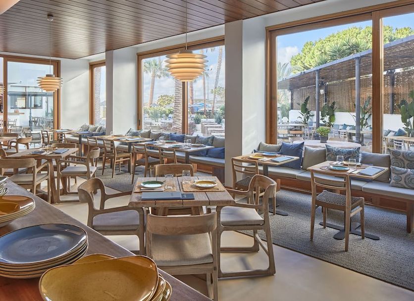 Hotel Tres Torres in Santa Eulària des Riu restaurant with large windows and sea-view seating