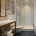 Hotel Louvre Montana bathroom in Paris with glass shower, bathtub and tiled walls