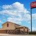 Red Roof Inn & Suites Denton exterior with roadside sign under a blue sky in Denton