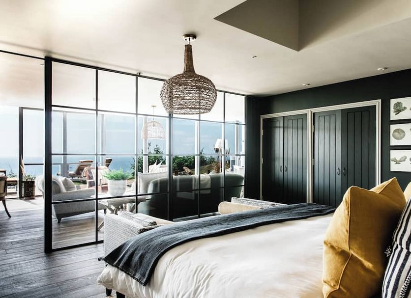 Gara Rock in Salcombe bedroom with glass doors opening to a sea-view terrace