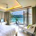 Impiana Private Villas Kata Noi in Karon: bedroom with ocean-view balcony, lounge chair and island scenery