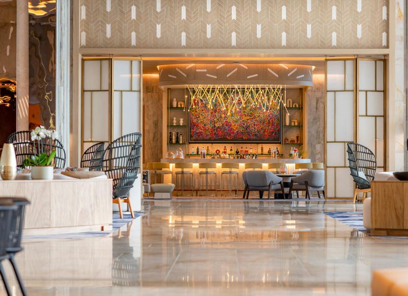 Waldorf Astoria Riviera Maya in Cancún lobby lounge with colorful bar and polished marble floor