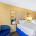La Quinta Inn & Suites by Wyndham Sarasota Downtown guest room with two double beds and lamp in Sarasota