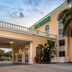 La Quinta Inn & Suites by Wyndham Sarasota Downtown exterior entrance in Sarasota with palm trees