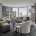 Four Seasons Hotel One Dalton Street, Boston suite with city skyline views, curved windows and seating area
