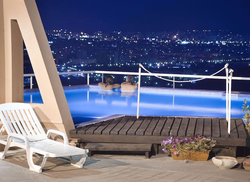 Hotel Bel 3 in Palermo rooftop pool terrace with city lights at night