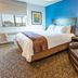 My Place Hotel-Idaho Falls, Idaho Falls guest room with king bed, leather chair, and city view